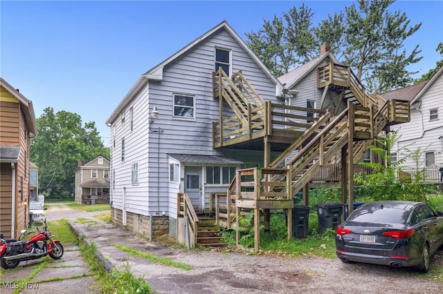 523 Gage St, Akron, OH 44311 - view of front facade with stairway, a chimney, and a deck