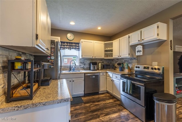 135 S 31st St, Newark, OH 43055 - kitchen with appliances with stainless steel finishes, dark wood finished floors, white cabinetry, a textured ceiling, and open shelves
