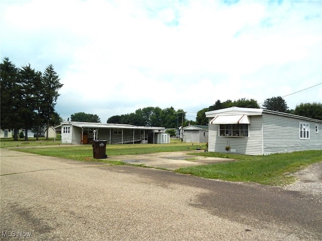 400 N George St, West Lafayette, OH 43845 - view of front of property with driveway, a front yard, and an outbuilding