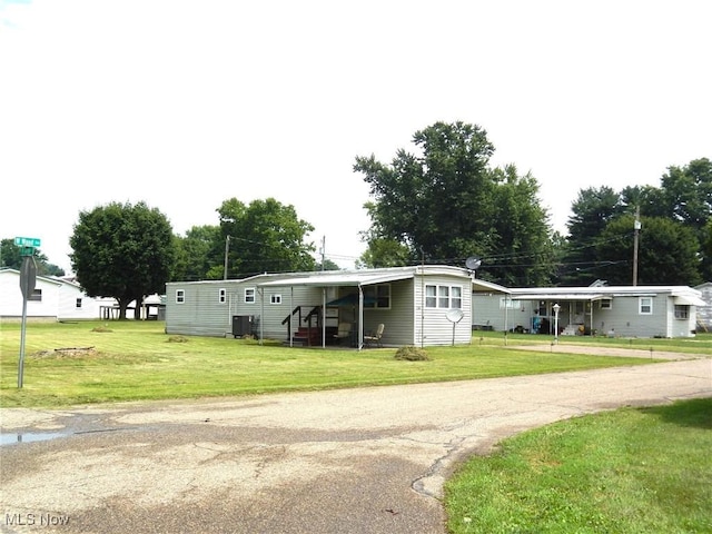 400 N George St, West Lafayette, OH 43845 - view of front facade with a front yard, driveway, and an attached carport
