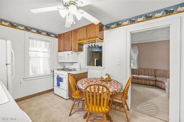 192 Swartz Rd, Akron, OH 44319 - kitchen featuring white appliances, ceiling fan, brown cabinets, and light countertops