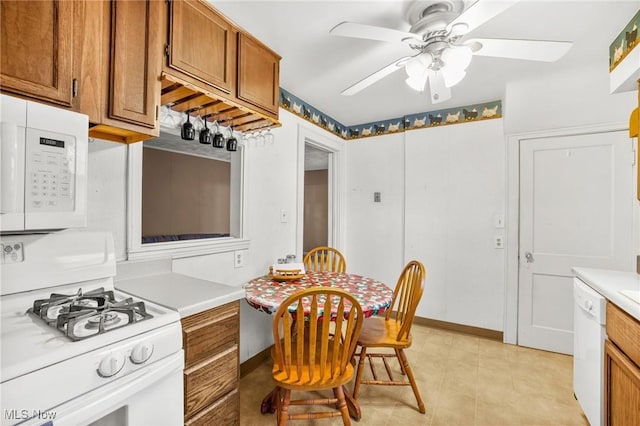 192 Swartz Rd, Akron, OH 44319 - kitchen featuring white appliances, brown cabinetry, light countertops, ceiling fan, and light tile patterned floors