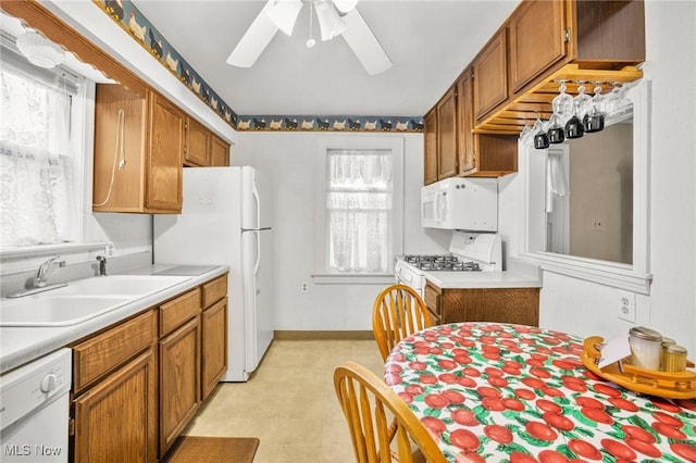 192 Swartz Rd, Akron, OH 44319 - kitchen featuring ceiling fan, white appliances, brown cabinetry, and light countertops