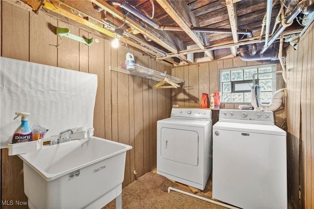 192 Swartz Rd, Akron, OH 44319 - laundry area with washing machine and clothes dryer, wooden walls, and carpet flooring