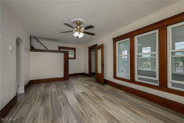 41 New St, Barberton, OH 44203 - spare room with arched walkways, wood finished floors, and ceiling fan