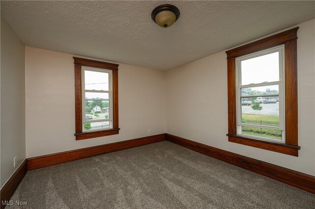 41 New St, Barberton, OH 44203 - empty room with carpet floors and a textured ceiling