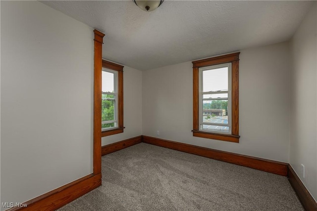 41 New St, Barberton, OH 44203 - carpeted spare room featuring healthy amount of natural light and a textured ceiling