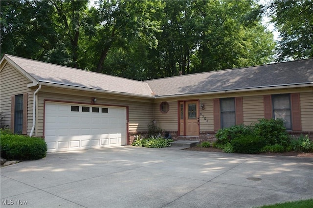 8303 Bradfords Gate Rd, Olmsted Falls, OH 44138 - ranch-style house with an attached garage, concrete driveway, a shingled roof, and brick siding
