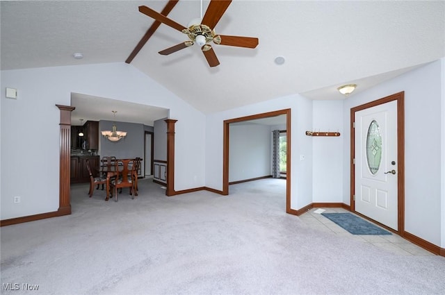 1137 Saint Abigail St SW, Hartville, OH 44632 - carpeted entrance foyer with a chandelier, vaulted ceiling, and a ceiling fan