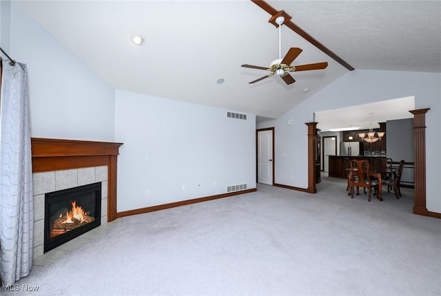 1137 Saint Abigail St SW, Hartville, OH 44632 - living room with a tile fireplace, a ceiling fan, light carpet, a chandelier, and beamed ceiling