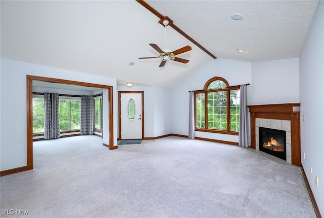 1137 Saint Abigail St SW, Hartville, OH 44632 - unfurnished living room featuring carpet floors, a ceiling fan, a fireplace, and a textured ceiling