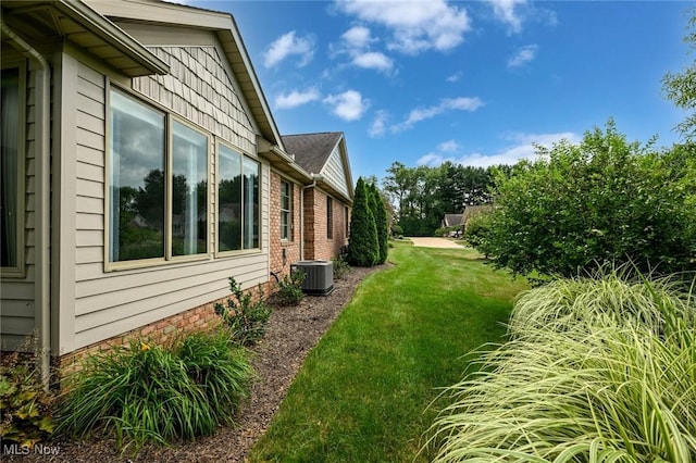 1137 Saint Abigail St SW, Hartville, OH 44632 - view of side of property featuring a lawn and brick siding