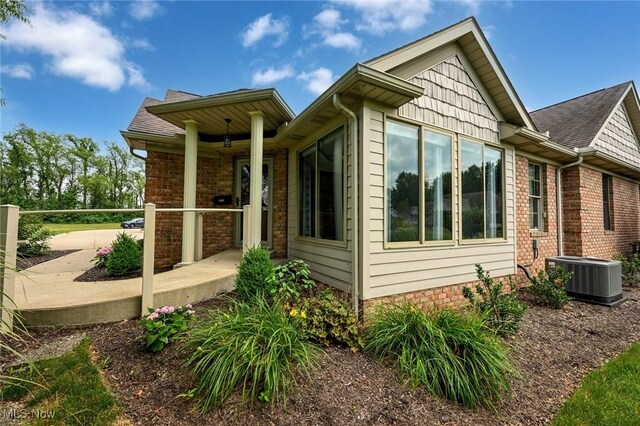 1137 Saint Abigail St SW, Hartville, OH 44632 - view of side of home with brick siding and a shingled roof