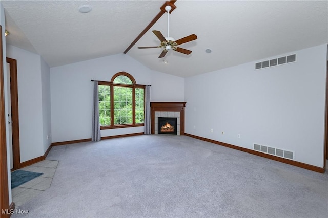1137 Saint Abigail St SW, Hartville, OH 44632 - unfurnished living room featuring light carpet, lofted ceiling, a fireplace, and ceiling fan
