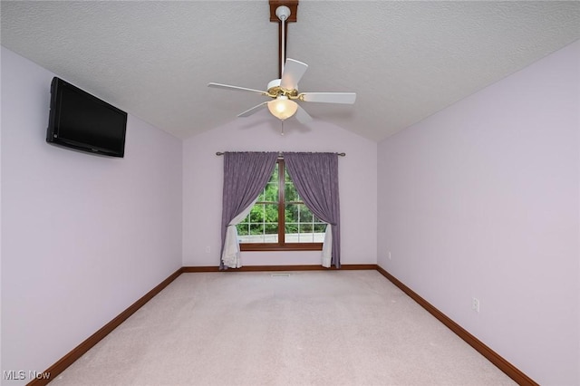 1137 Saint Abigail St SW, Hartville, OH 44632 - unfurnished room with ceiling fan, light colored carpet, a textured ceiling, and vaulted ceiling