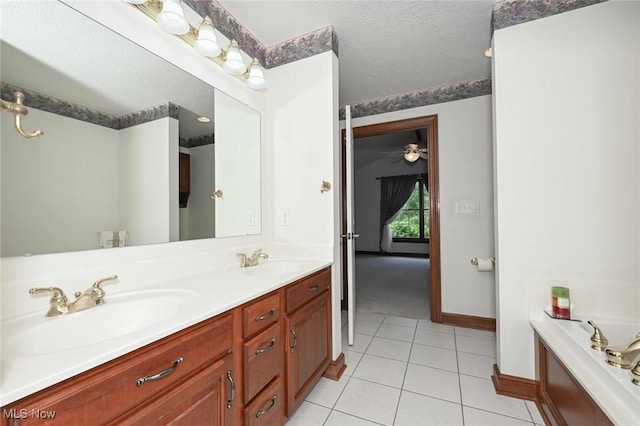 1137 Saint Abigail St SW, Hartville, OH 44632 - bathroom featuring double vanity, tile patterned floors, a tub, and a textured ceiling