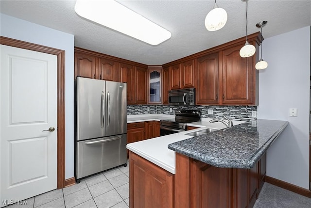 1137 Saint Abigail St SW, Hartville, OH 44632 - kitchen featuring appliances with stainless steel finishes, a peninsula, tasteful backsplash, glass insert cabinets, and decorative light fixtures