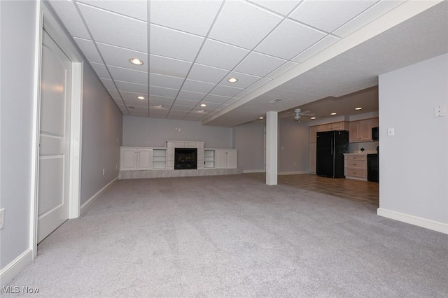 1137 Saint Abigail St SW, Hartville, OH 44632 - unfurnished living room featuring light carpet, recessed lighting, a fireplace, ceiling fan, and a paneled ceiling
