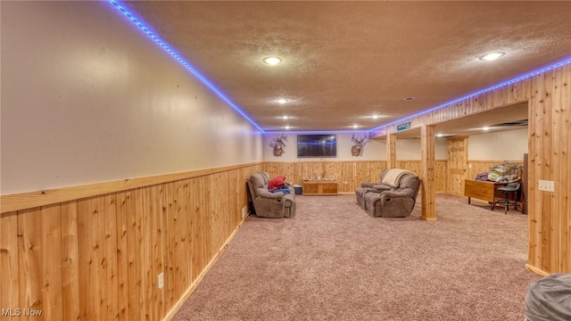 48820 Hillcrest Dr, Caldwell, OH 43724 - carpeted living area featuring a wainscoted wall, a textured ceiling, and wooden walls