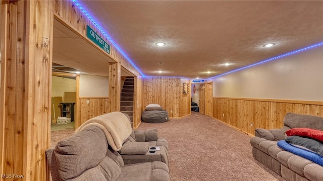 48820 Hillcrest Dr, Caldwell, OH 43724 - home theater room featuring wooden walls, wainscoting, carpet, a textured ceiling, and recessed lighting