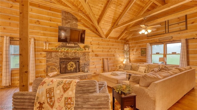 48820 Hillcrest Dr, Caldwell, OH 43724 - living room featuring a wood ceiling with exposed beams, wood walls, wood finished floors, ceiling fan, and a stone fireplace
