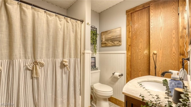 48820 Hillcrest Dr, Caldwell, OH 43724 - full bath with wainscoting, vanity, a textured ceiling, and a shower with curtain