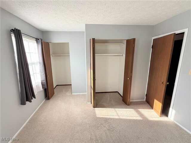 1489 Munroe Falls Ave, Cuyahoga Falls, OH 44221 - unfurnished bedroom with light carpet and a textured ceiling