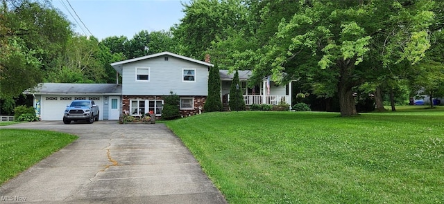 5248 State Route 303, Ravenna, OH 44266 - tri-level home with driveway, an attached garage, a front lawn, and brick siding
