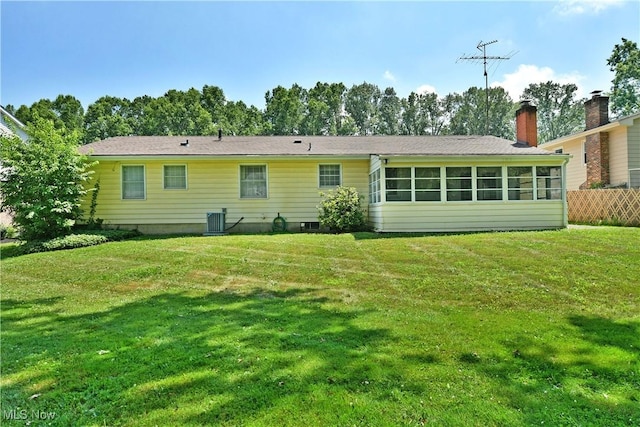 2741 Citadel Dr NE, Warren, OH 44483 - back of property featuring a sunroom, a yard, and a chimney