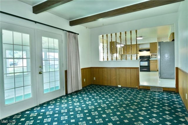 2741 Citadel Dr NE, Warren, OH 44483 - kitchen featuring french doors, freestanding refrigerator, beam ceiling, black electric range, and carpet floors