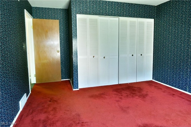 2741 Citadel Dr NE, Warren, OH 44483 - unfurnished bedroom featuring wallpapered walls, carpet floors, and a closet