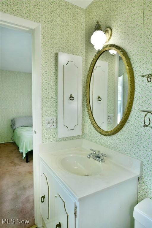 2741 Citadel Dr NE, Warren, OH 44483 - bathroom featuring vanity and wallpapered walls
