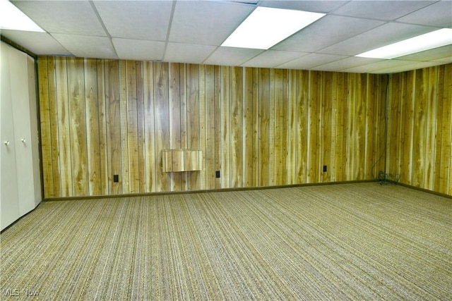 2741 Citadel Dr NE, Warren, OH 44483 - spare room with a paneled ceiling, carpet flooring, and wood walls