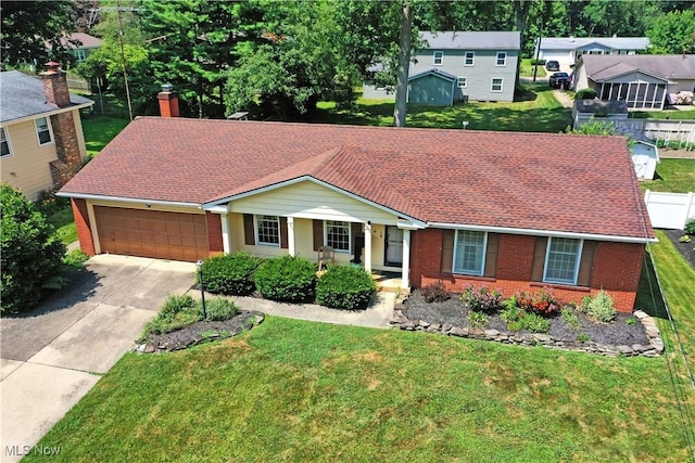 2741 Citadel Dr NE, Warren, OH 44483 - view of front of property with brick siding, concrete driveway, a garage, a chimney, and roof with shingles