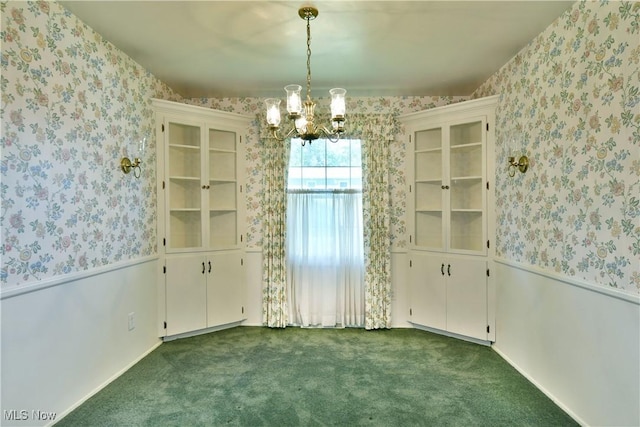 2741 Citadel Dr NE, Warren, OH 44483 - unfurnished dining area with wallpapered walls, a chandelier, a wainscoted wall, and dark colored carpet