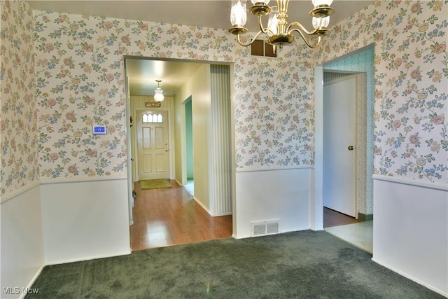 2741 Citadel Dr NE, Warren, OH 44483 - hallway featuring wallpapered walls, carpet floors, and a chandelier