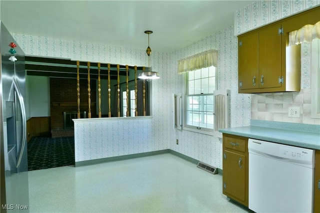 2741 Citadel Dr NE, Warren, OH 44483 - kitchen featuring wallpapered walls, dishwasher, stainless steel fridge, decorative light fixtures, and light countertops
