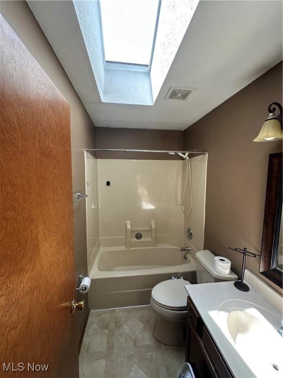 6279 Palmer Dr NW, Canton, OH 44718 - full bathroom featuring a skylight, vanity, shower / bathtub combination, and tile patterned flooring