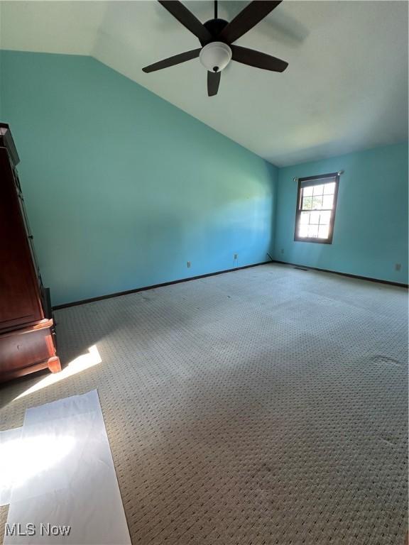 6279 Palmer Dr NW, Canton, OH 44718 - carpeted empty room featuring vaulted ceiling and a ceiling fan