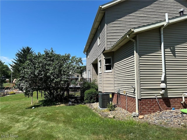 6279 Palmer Dr NW, Canton, OH 44718 - view of home's exterior with a lawn and a central AC unit