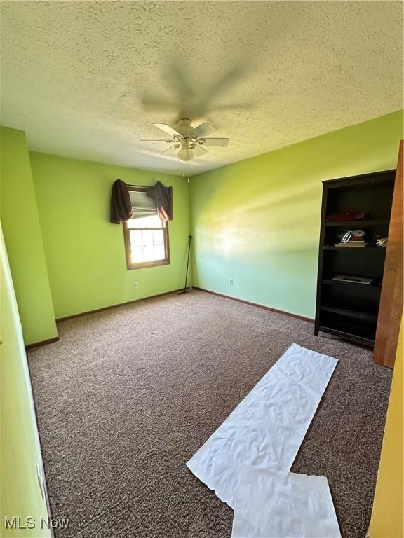 6279 Palmer Dr NW, Canton, OH 44718 - unfurnished room featuring carpet flooring, a textured ceiling, and a ceiling fan