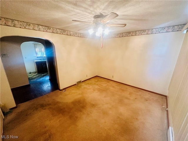 668 Virginia Ave, Follansbee, WV 26037 - carpeted empty room with ceiling fan, arched walkways, and a textured ceiling