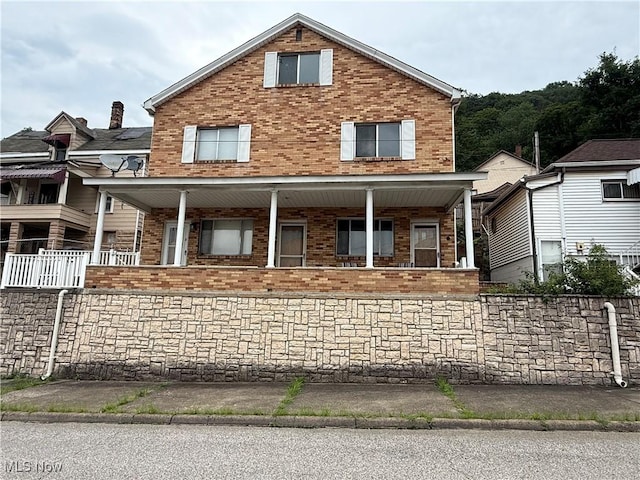 668 Virginia Ave, Follansbee, WV 26037 - view of front facade with brick siding and covered porch