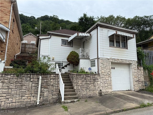 668 Virginia Ave, Follansbee, WV 26037 - view of front of home with stairs, stone siding, a garage, and driveway