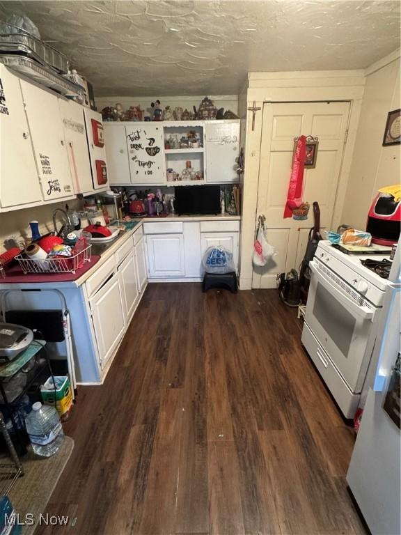 526 Madison Ave, Akron, OH 44320 - kitchen featuring white cabinetry, dark wood-style flooring, open shelves, white gas stove, and fridge