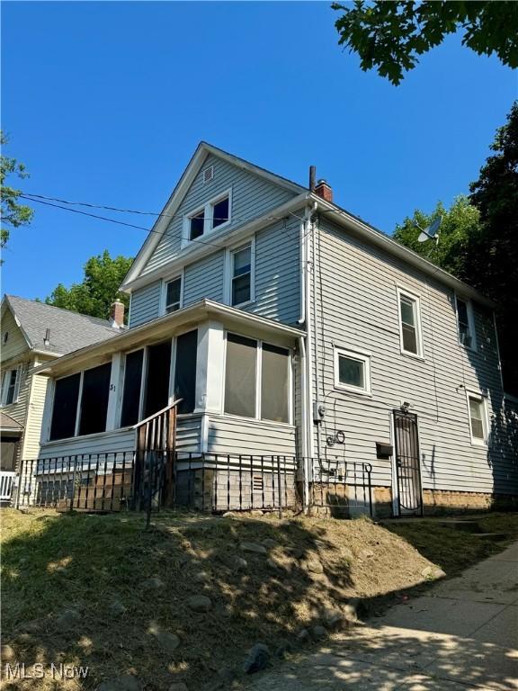 31 E Emerling Ave, Akron, OH 44301 - back of house featuring a sunroom and a chimney