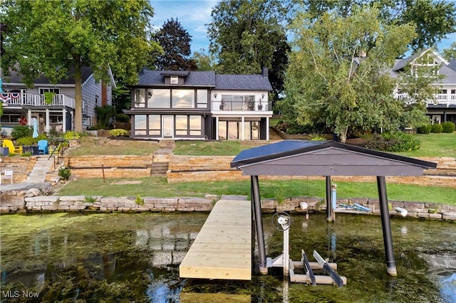 3350 S Main St, Akron, OH 44319 - dock area featuring a balcony, boat lift, a water view, and a lawn