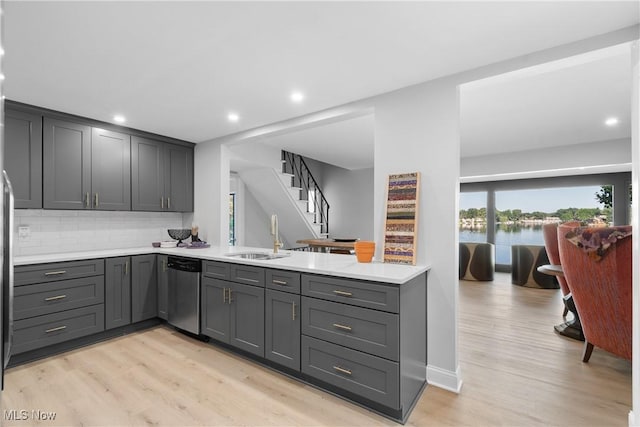 3350 S Main St, Akron, OH 44319 - kitchen featuring gray cabinets, light countertops, light wood-style flooring, decorative backsplash, and recessed lighting