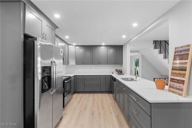 3350 S Main St, Akron, OH 44319 - kitchen with gray cabinetry, stainless steel appliances, light wood-type flooring, decorative backsplash, and recessed lighting