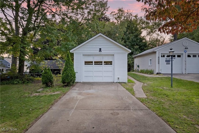 3350 S Main St, Akron, OH 44319 - garage at dusk with a detached garage and a yard